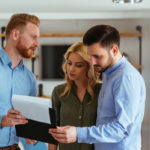 real estate agent going over deal memo with buyers real estate agent going over deal memo with buyers