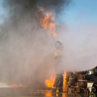 Firemen are using water to extinguish the fire. Firefighter training