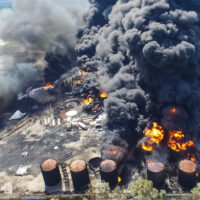 Oil storage fire. The tank farm is burning, black smoke is combu Oil storage fire. The tank farm is burning, black smoke is combu