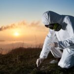 Scientist taking sample of ground at thermal power station. Scientist taking sample of ground at thermal power station.