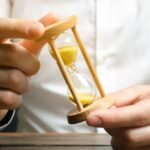 Businessman holds clock in hands. Concept of saving time and money. Time management. Planning work. Reduced cost and bureaucratic burden. Saving productivity. Extension of life. Debt / tax holidays Businessman holds clock in hands. Concept of saving time and money. Time management. Planning work. Reduced cost and bureaucratic burden. Saving productivity. Extension of life. Debt / tax holidays