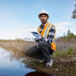 Marine biologist analysing water test results on a tablet in Canada