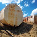 Old industrial rusty metal storage tanks - landscape color photo