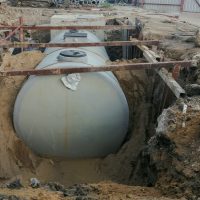 Gray building waste collection tanks are currently undergoing landfill operations, with sand and steel structures for placement, waste collection systems, basic public health systems. Septic tank for building.
