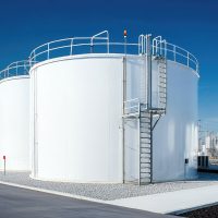 A white storage tank with a metal ladder running along its side, positioned in a clean and organized industrial yard. A white storage tank with a metal ladder running along its side, positioned in a clean and organized industrial yard.