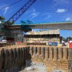 Temporary sheet pile cofferdam retaining wall at the construction site. It is installed to allow soil excavation and foundation work start.